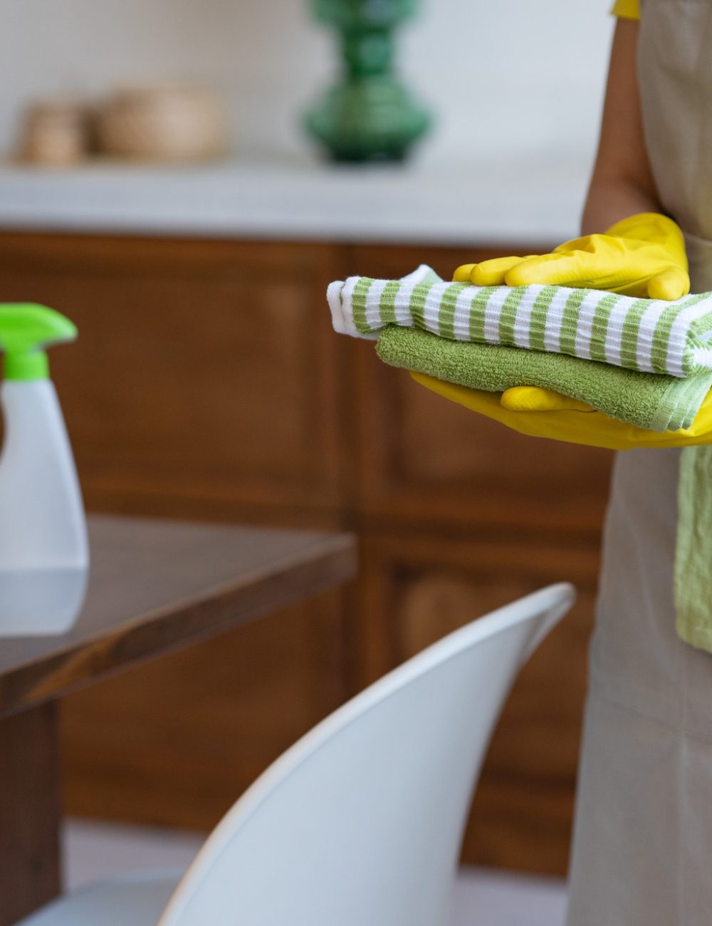 cleaning-service-a-woman-in-a-gray-apron-and-yellow-rubber-gloves-professional-cleaning.jpg